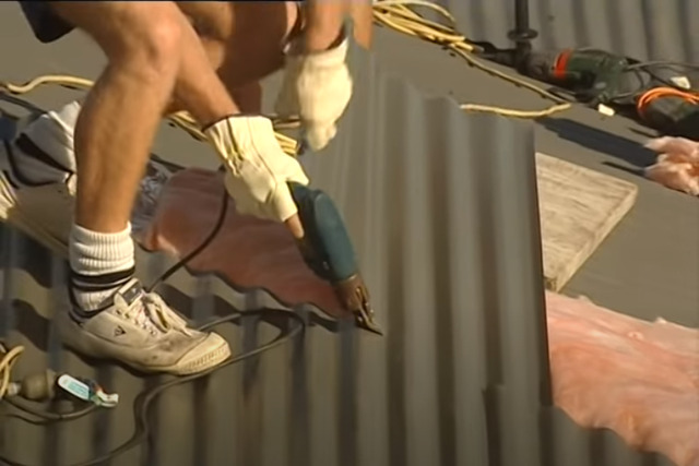 Carmel Roofing worker doing steel roof replacement