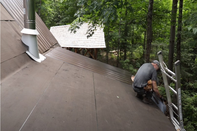 Installing a metal roof on a log cabin