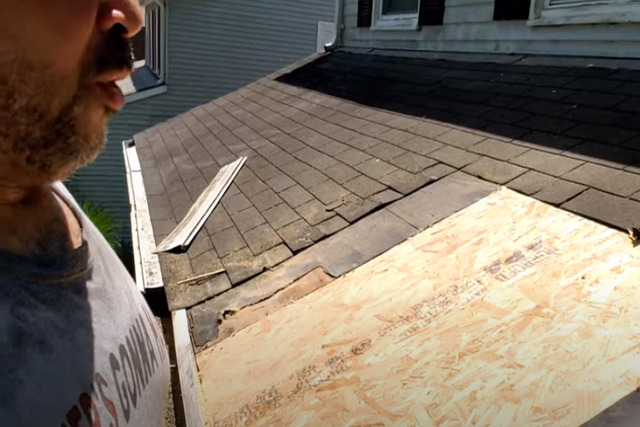 Carmel Roofing worker replacing rotten plywood on the roof